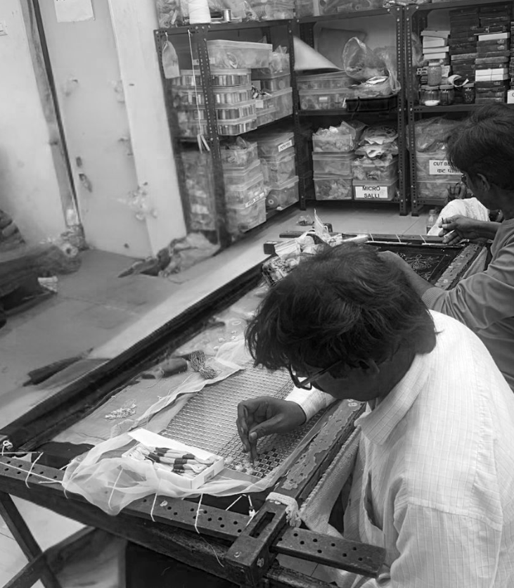 Artisan hand-embroidering a Musou garment